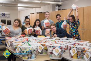 Students holding turkeys for the food drive baskets.