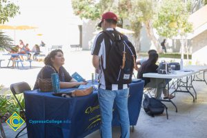 Staff member speaks to a student at Club Rush