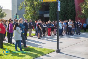 Students and staff standing on campus.