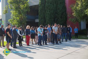 Students and staff standing on campus.