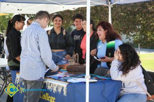 Puente booth with staff and students.