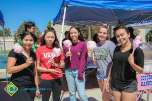 Happy students holding cotton candy.