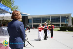 President JoAnna Schilling watching student dancers at Cypress College Fiesta.