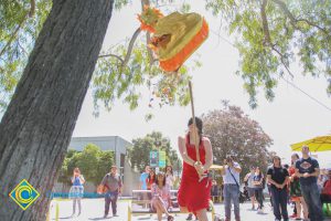 Blindfolded student hitting piñata.