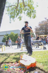 Blindfolded student hitting piñata.