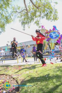 Blindfolded student hitting piñata.