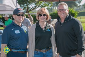 President, JoAnna Schilling and Howard Kummerman and a man wearing glasses and smiling.