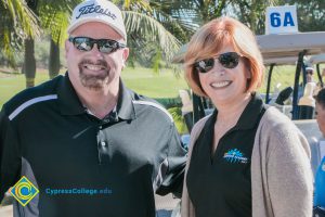 President, JoAnna Schilling with a gentleman in a black polo shirt and sunglasses.