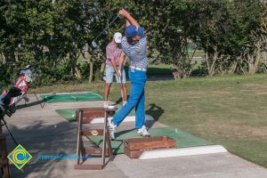 Golfers swinging.