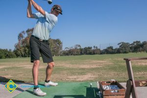 Golfers swinging.