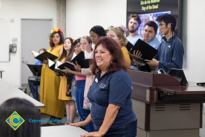 Dr. Mosqueda-Ponce speaking at the Dia de Los Muertos event