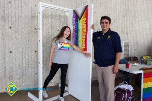 Two students standing at an open door at National Coming Out Day