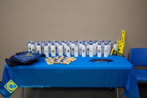 Cypress College water bottles and reusable bags on a table
