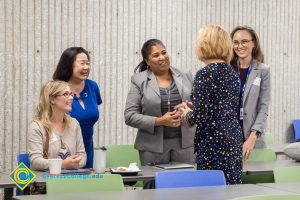 JoAnna Schilling speaks to four women at the Superintendent Breakfast.