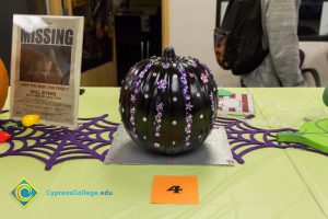 Black painted pumpkin with purple painted designs