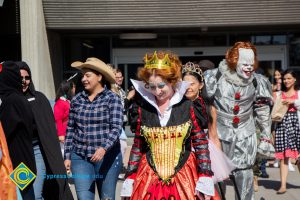 Students and staff wear Halloween costumes as they walk across campus