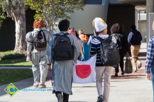 Students in Halloween costumes walking through campus