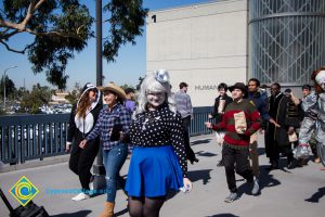 Students dressed in Halloween costumes like Freddy Kruger walk through campus