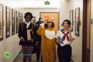 Students in Halloween costumes walking in hallway