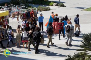 Students walking through campus in Halloween costumes