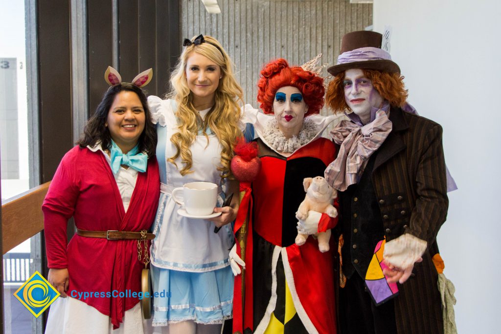 Staff dress as characters from Alice in Wonderland for campus Halloween party