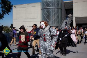 Students walking across campus in Halloween costumes