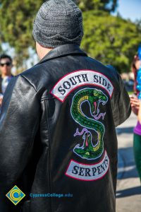 Man wearing leather jacket that reads South Side Serpents.