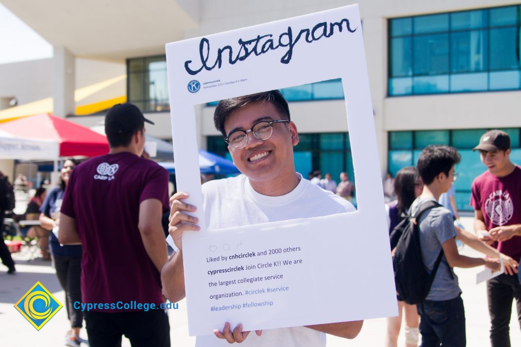 Student posing with an Instagram frame.