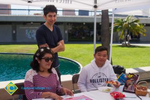 Students sitting at an information booth during Club Rush.