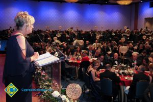 Audience at banquet tables watching a speaker at the 2018 Americana Awards.