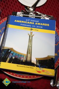 Table setting with red, white and blue plate, and the Americana Awards Program.