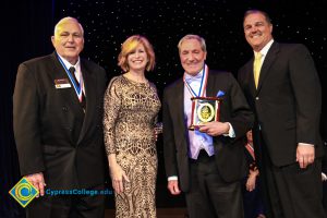 Dr. JoAnna Schilling with three men in suits and tie.