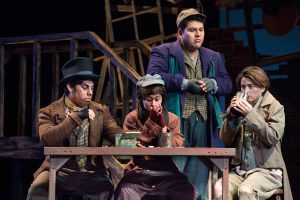 Students performing Oliver Twist on stage