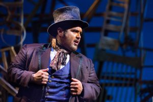 Actor wearing hat on stage