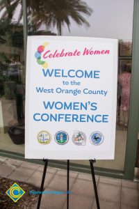 Easel with "Welcome to the West Orange County Women's Conference."