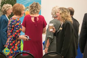 Dr. Schilling laughing with someone at the West Orange County Women's Conference.