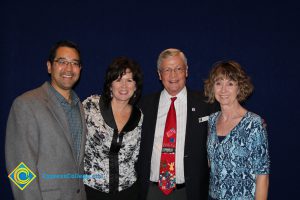 Lynn Mitts with a woman in a blue shirt and two gentlemen with glasses.