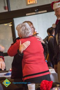 Staff embracing at the Holiday celebration.