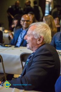 Side profile of a gentleman laughing.