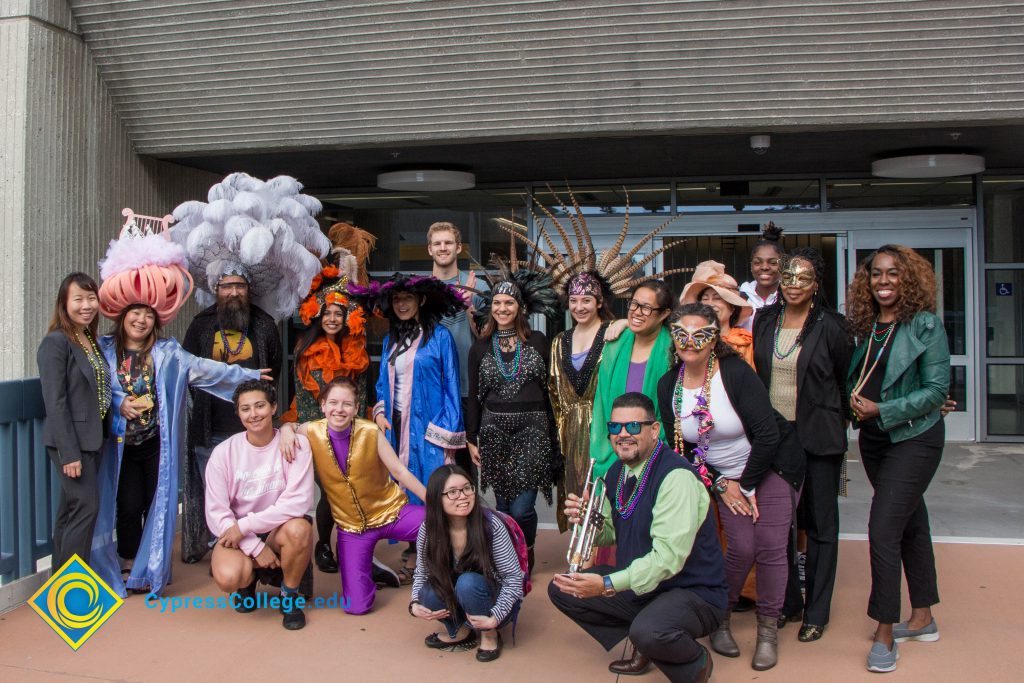 Employees and students dressed up in Mardi Gras gear