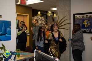 Employees and students dressed up for and participating in Mardi Gras parade