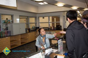 Participants of Mardi Gras parade handing out beads in DSS office