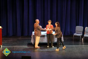 A student being congratulated as she receives her award at the 2014 Scholarship Awards Ceremony.