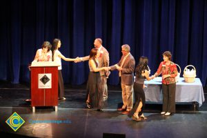 A student being congratulated as she receives her award at the 2014 Scholarship Awards Ceremony.