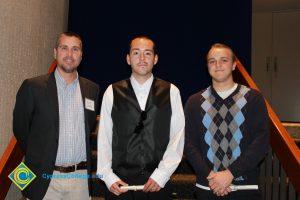 Professor Keith Vescial with a two young men one with white shirt and black vest and the other with an argyle sweater.