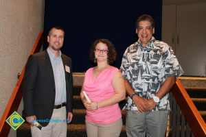 Professor Keith Vescial with a woman in a pink shirt and tan pants and a man with a grey and white shirt and grey pants.