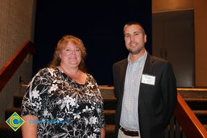 Professor Keith Vescial with a woman in a black and white blouse.