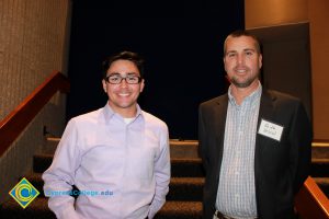 Professor Keith Vescial with a young man in a button down shirt.