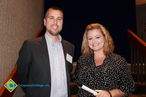 Professor Keith Vescial with a young lady in a black and white blouse.