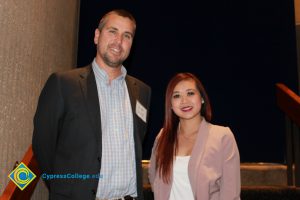 Professor Keith Vescial with a young lady in a white blouse and light pink jacket.